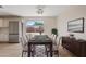 Elegant dining room features modern lighting, a dining table set for eight, and backyard views at 2022 N 61St Ave, Phoenix, AZ 85035