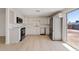 Bright kitchen features white cabinets, stainless steel appliances, and light wood flooring at 2022 N 61St Ave, Phoenix, AZ 85035