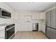 Modern kitchen featuring white cabinets, stainless steel appliances, and a functional layout at 2022 N 61St Ave, Phoenix, AZ 85035