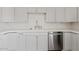 Updated kitchen with white cabinets, quartz countertops, and stainless steel dishwasher and sink at 2022 N 61St Ave, Phoenix, AZ 85035