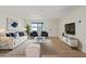 Staged living room with wood floors, white walls, modern furnishings, and ample natural light at 2022 N 61St Ave, Phoenix, AZ 85035