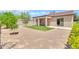 Backyard with a covered patio, gravel, greenery, and block fence at 209 E Diamond Trl, San Tan Valley, AZ 85143