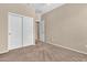 Bright bedroom with carpet flooring, closet space, and a view of the hallway at 209 E Diamond Trl, San Tan Valley, AZ 85143