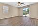 Bedroom featuring wood floors, ceiling fan, and backyard view at 209 E Diamond Trl, San Tan Valley, AZ 85143