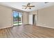 Spacious bedroom with wood floors, ceiling fan, and sliding glass door to the backyard at 209 E Diamond Trl, San Tan Valley, AZ 85143