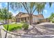Landscaped front yard featuring mature tree providing ample shade with a view of the home's facade at 209 E Diamond Trl, San Tan Valley, AZ 85143