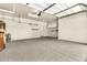 Clean garage with epoxy floors and storage racks on the ceiling and walls at 209 E Diamond Trl, San Tan Valley, AZ 85143