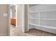 Hallway with tile flooring, a view of the bathroom and a closet with shelving at 209 E Diamond Trl, San Tan Valley, AZ 85143