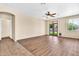 Spacious living room with wood flooring, ceiling fan and double doors leading to backyard at 209 E Diamond Trl, San Tan Valley, AZ 85143