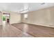 Living room features wood and tile flooring and access to the kitchen at 209 E Diamond Trl, San Tan Valley, AZ 85143