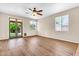 Bright living room with wood floors, windows and doors with access to the backyard at 209 E Diamond Trl, San Tan Valley, AZ 85143