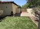 Beautiful backyard area featuring artificial turf, a paved patio, and a garden area at 21183 W Main St, Buckeye, AZ 85396