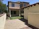 Charming backyard featuring a covered patio, pavers, and a small section of artificial turf at 21183 W Main St, Buckeye, AZ 85396
