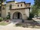 Charming two-story home with a tile roof, arched entryway, and well-manicured landscaping at 21183 W Main St, Buckeye, AZ 85396
