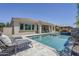 Expansive backyard with pool, spa, outdoor kitchen, and covered patio at 22255 E Quintero Rd, Queen Creek, AZ 85142