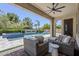Inviting outdoor living space with covered patio, comfortable seating, pool, and spa at 22255 E Quintero Rd, Queen Creek, AZ 85142