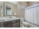 Well-lit bathroom boasts a single vanity, a large mirror, and a shower-tub combo, combining style with functionality at 22255 E Quintero Rd, Queen Creek, AZ 85142