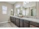 Well-lit bathroom with double vanity, granite countertop, and decorative accents at 22255 E Quintero Rd, Queen Creek, AZ 85142