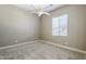 This bedroom features neutral walls, a ceiling fan, and carpet, creating a serene retreat for relaxation at 22255 E Quintero Rd, Queen Creek, AZ 85142