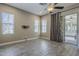 This bedroom is spacious with sleek wood tile and a sliding door leading to a charming outdoor patio at 22255 E Quintero Rd, Queen Creek, AZ 85142