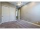 Relaxing bedroom with plush carpeting, neutral walls, a ceiling fan, and a convenient closet space at 22255 E Quintero Rd, Queen Creek, AZ 85142