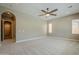 Bright bedroom with neutral carpet, large windows and archway leading to the bathroom at 22255 E Quintero Rd, Queen Creek, AZ 85142