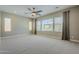 Spacious carpeted bedroom with large windows offering ample natural light and backyard views at 22255 E Quintero Rd, Queen Creek, AZ 85142