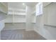 Walk-in closet with custom shelving and ample storage space for organization at 22255 E Quintero Rd, Queen Creek, AZ 85142