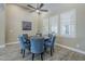 Elegant dining area with a round wood table, upholstered chairs and plantation shutters at 22255 E Quintero Rd, Queen Creek, AZ 85142