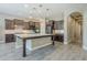 Modern kitchen featuring dark cabinetry, a large island, and stainless steel appliances at 22255 E Quintero Rd, Queen Creek, AZ 85142