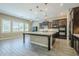 Modern kitchen featuring dark cabinetry, a large island, and stainless steel appliances at 22255 E Quintero Rd, Queen Creek, AZ 85142