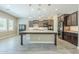 Modern kitchen featuring dark cabinetry, a large island, and stainless steel appliances at 22255 E Quintero Rd, Queen Creek, AZ 85142