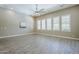 Bright living room showcasing tile floors and plantation shutters for natural light control at 22255 E Quintero Rd, Queen Creek, AZ 85142