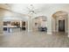 Open-concept living area featuring tile floors, arched doorways and views to the kitchen at 22255 E Quintero Rd, Queen Creek, AZ 85142