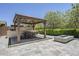 Outdoor kitchen with grill, dining table, and fire pit at 22255 E Quintero Rd, Queen Creek, AZ 85142