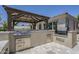 Built-in outdoor kitchen with a stainless steel grill at 22255 E Quintero Rd, Queen Creek, AZ 85142