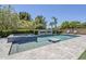 Sparkling pool and spa surrounded by a spacious patio and lush landscaping at 22255 E Quintero Rd, Queen Creek, AZ 85142