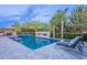 Beautiful backyard pool with stone surround, fireplace, and lush landscaping at 22255 E Quintero Rd, Queen Creek, AZ 85142