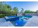 Inviting pool with integrated spa, in-pool seating, and stone fireplace feature at 22255 E Quintero Rd, Queen Creek, AZ 85142