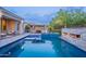 Stunning pool with covered outdoor kitchen, fireplace and lush greenry at 22255 E Quintero Rd, Queen Creek, AZ 85142