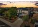 Sunset aerial view of home featuring solar panels and low maintenance landscaping at 22341 N 100Th Ln, Peoria, AZ 85383