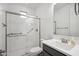 Modern bathroom featuring a glass enclosed shower, sink and grab bars at 22341 N 100Th Ln, Peoria, AZ 85383