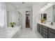 Elegant bathroom featuring a soaking tub, glass shower, and double vanity at 22341 N 100Th Ln, Peoria, AZ 85383