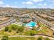 Aerial view of neighborhood pool and park, surrounded by residences, green spaces, and well maintained landscaping at 22341 N 100Th Ln, Peoria, AZ 85383
