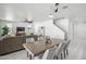 Bright dining area with a wooden table, gray chairs, and an open view of the living room at 22341 N 100Th Ln, Peoria, AZ 85383