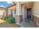 Inviting front porch with stone accents on the columns, offering a warm welcome at 22341 N 100Th Ln, Peoria, AZ 85383