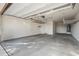 Large, clean garage with overhead storage racks, ready for vehicles and projects at 22341 N 100Th Ln, Peoria, AZ 85383