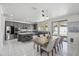 Open-concept kitchen with gray cabinets, stainless steel appliances, and a dining area with sliding glass doors at 22341 N 100Th Ln, Peoria, AZ 85383