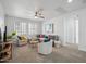 Spacious living room featuring a ceiling fan, bright windows, modern furniture and decor at 22341 N 100Th Ln, Peoria, AZ 85383