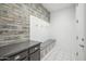 Mudroom with bench, hooks, storage and decorative wood wall at 22341 N 100Th Ln, Peoria, AZ 85383